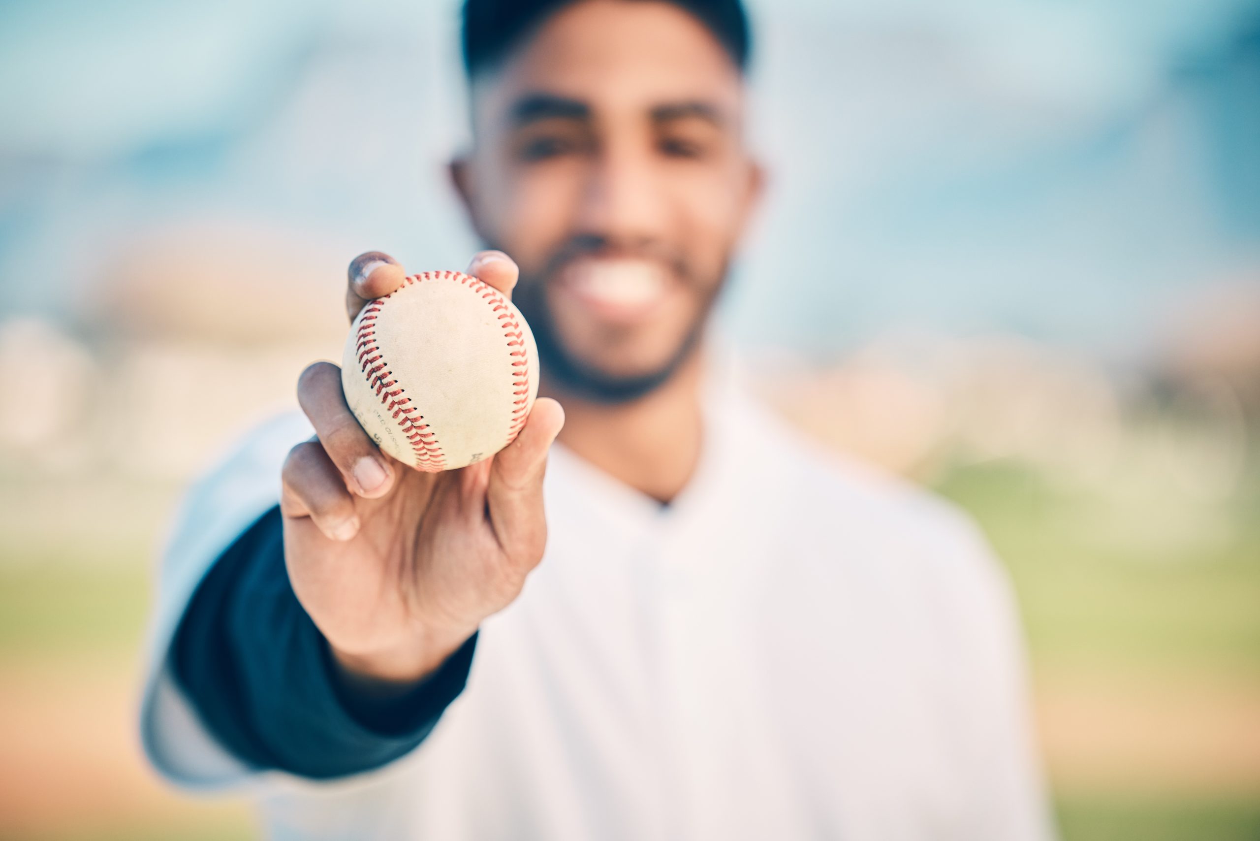 Baseball field, portrait and pitcher holding ball on match or game day on a sports ground or pitch .